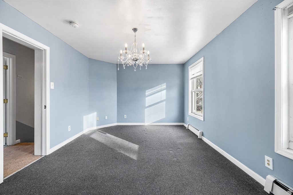 22 Pleasant Street, Unit D Lawrence, MA 01841 - Photo 14 of 32 a view of a chandelier in big room and chandelier