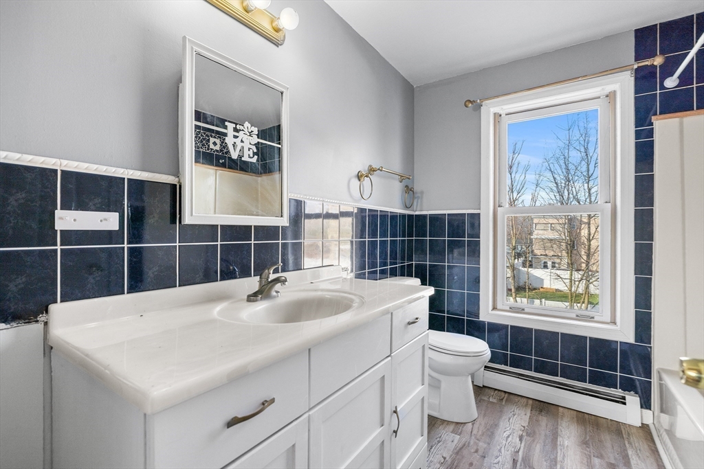 22 Pleasant Street, Unit D Lawrence, MA 01841 - Photo 15 of 32 a bathroom with a sink toilet and shower