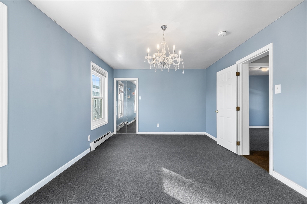 22 Pleasant Street, Unit D Lawrence, MA 01841 - Photo 17 of 32 a view of a chandelier in big room and chandelier