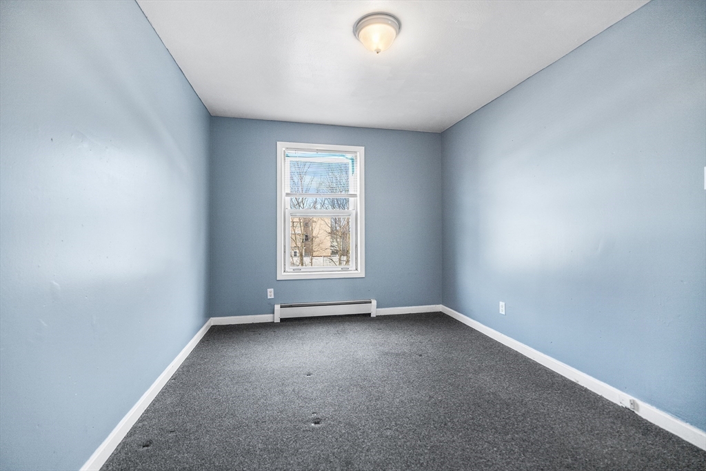 22 Pleasant Street, Unit D Lawrence, MA 01841 - Photo 18 of 32 an empty room with a window