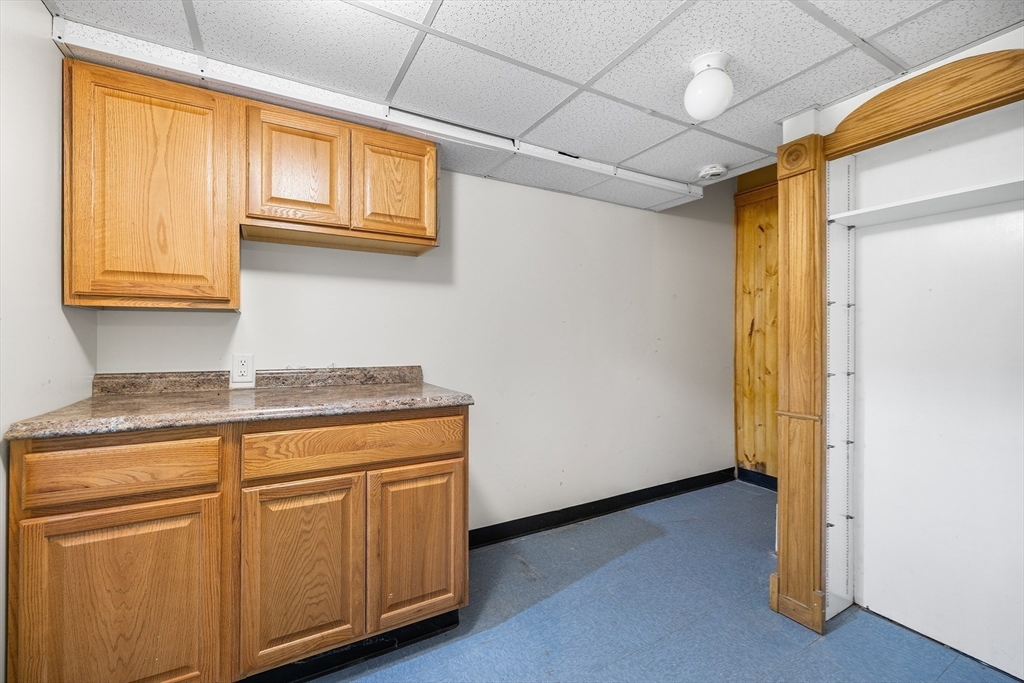 22 Pleasant Street, Unit D Lawrence, MA 01841 - Photo 21 of 32 a view of a kitchen with wooden floor and cabinets