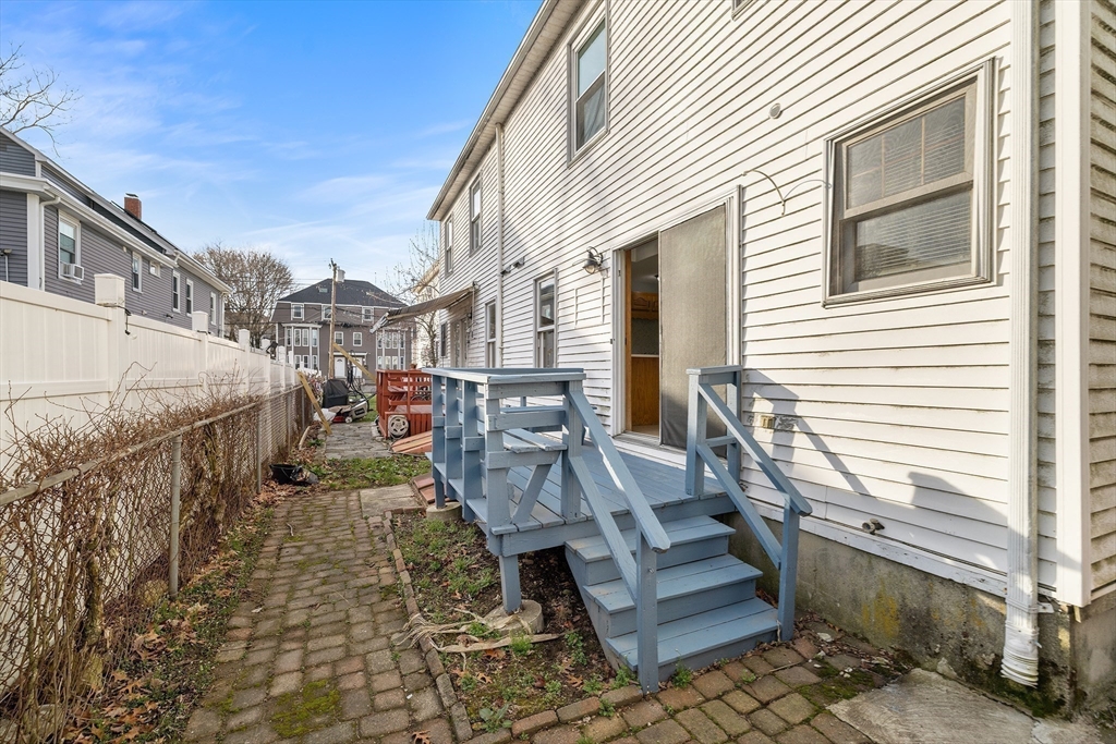 22 Pleasant Street, Unit D Lawrence, MA 01841 - Photo 27 of 32 a view of a patio with couches chairs and a wooden floor