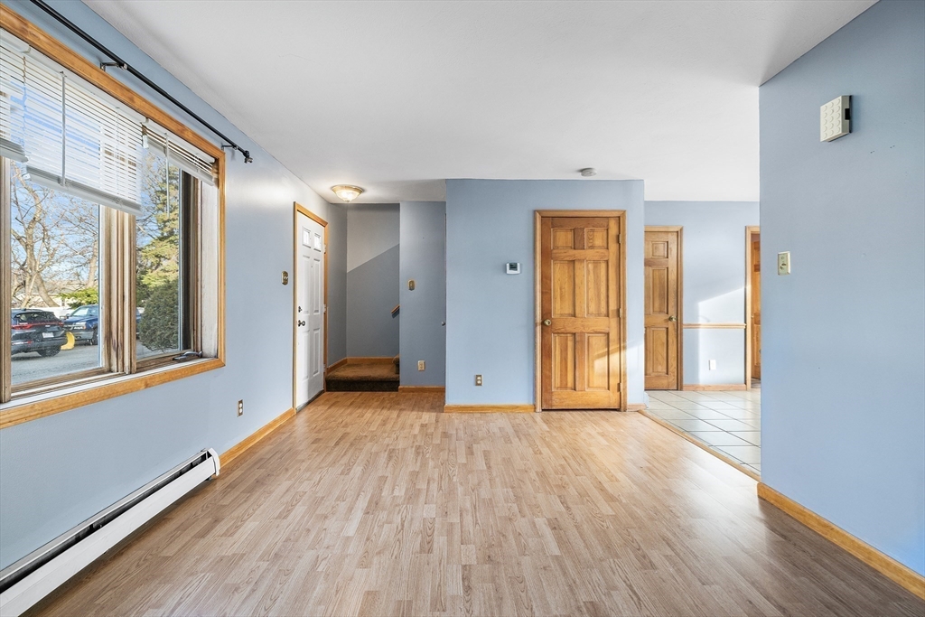 22 Pleasant Street, Unit D Lawrence, MA 01841 - Photo 4 of 32 a view of an empty room with wooden floor and a window