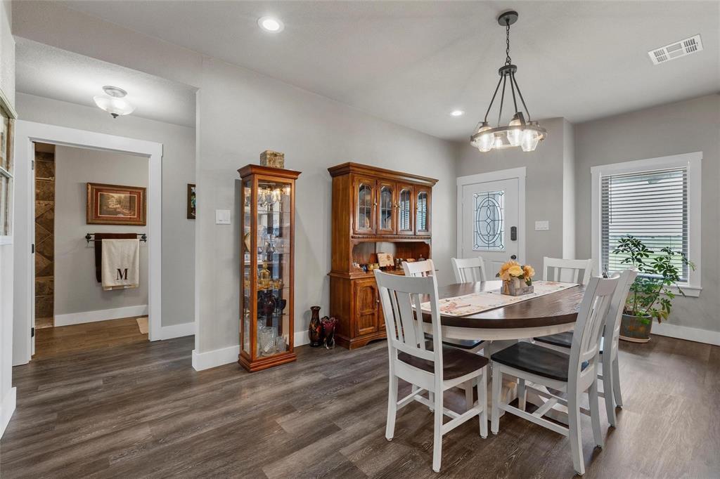 11541 Old Dallas Road West, TX 76691 - Photo 9 of 39 a dining room with furniture a chandelier and wooden floor