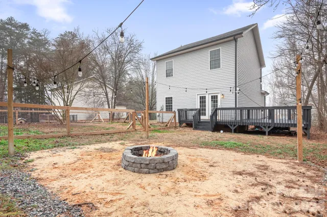 a view of a house with a patio and a yard