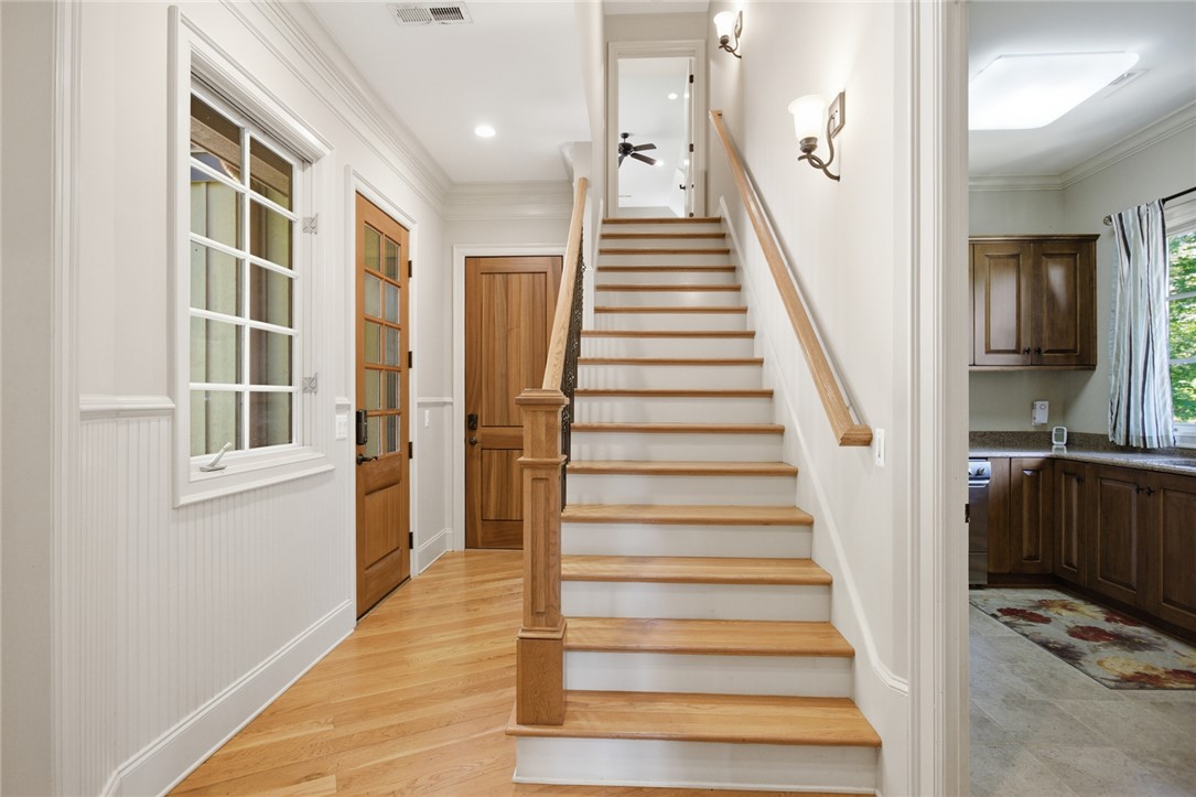 130 River Ridge Road Sunset, SC 29685 - Photo 18 of 47 A graceful staircase with natural wood treads and white risers beckons upstairs, while warm wood flooring extends into a welcoming entry.