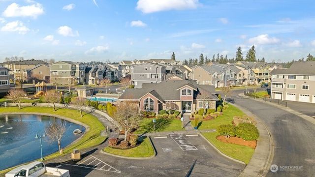 a view of a swimming pool with outdoor seating and city view