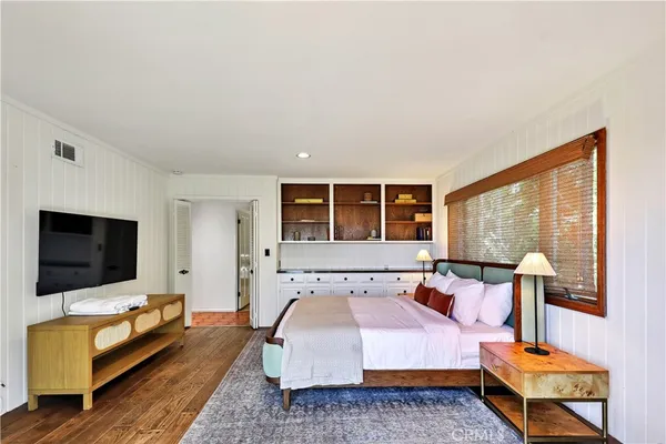 a bedroom with a bed and a television