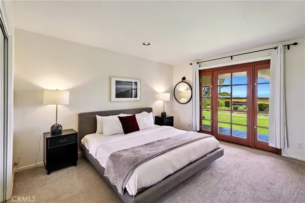 a spacious bathroom with a granite countertop sink and a mirror
