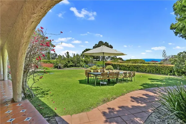 a view of a garden with a bench in the garden