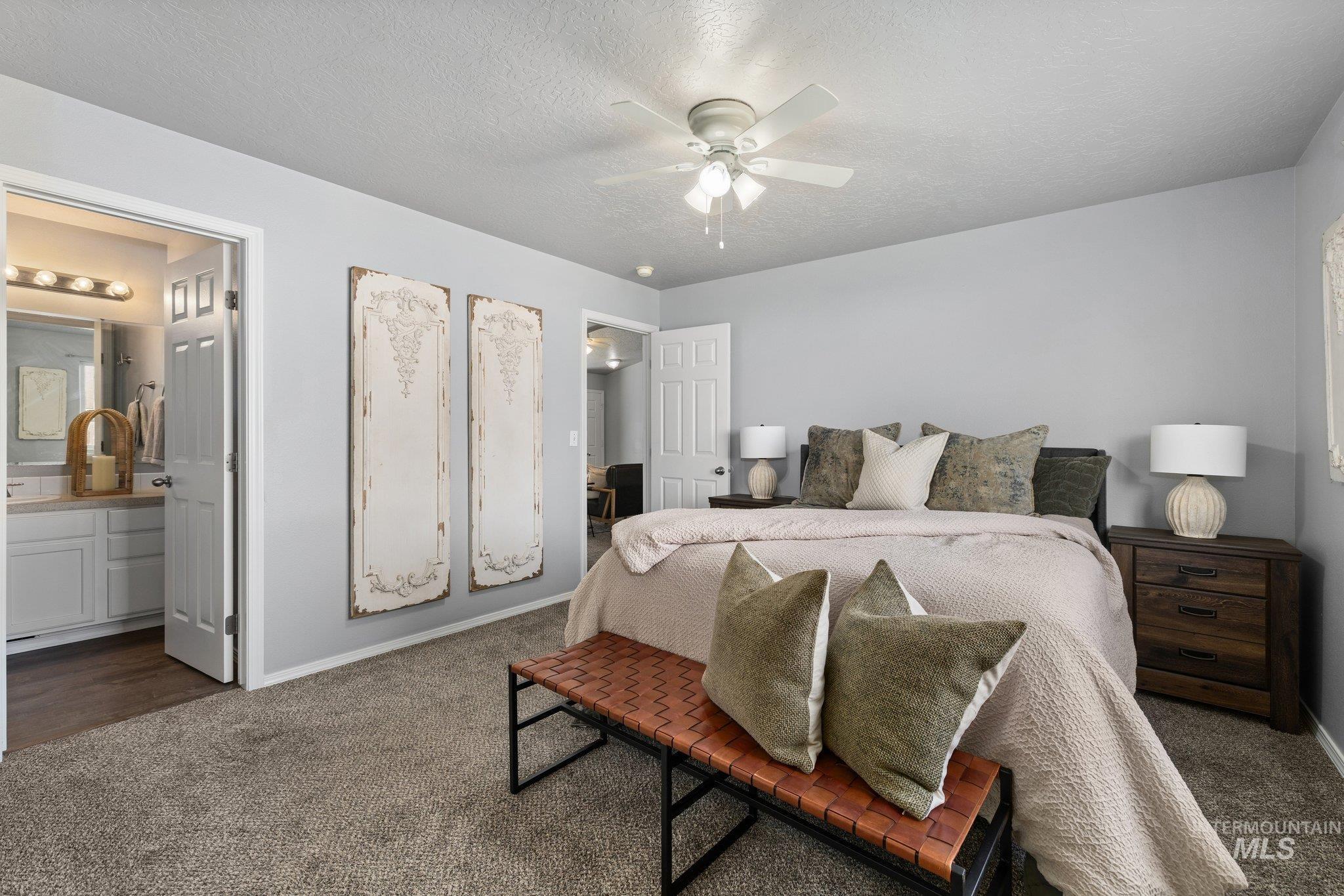 14250 Blue Ridge Street Caldwell, ID 83607 - Photo 18 of 33 Carpeted bedroom with a textured ceiling, ceiling fan, and ensuite bath
