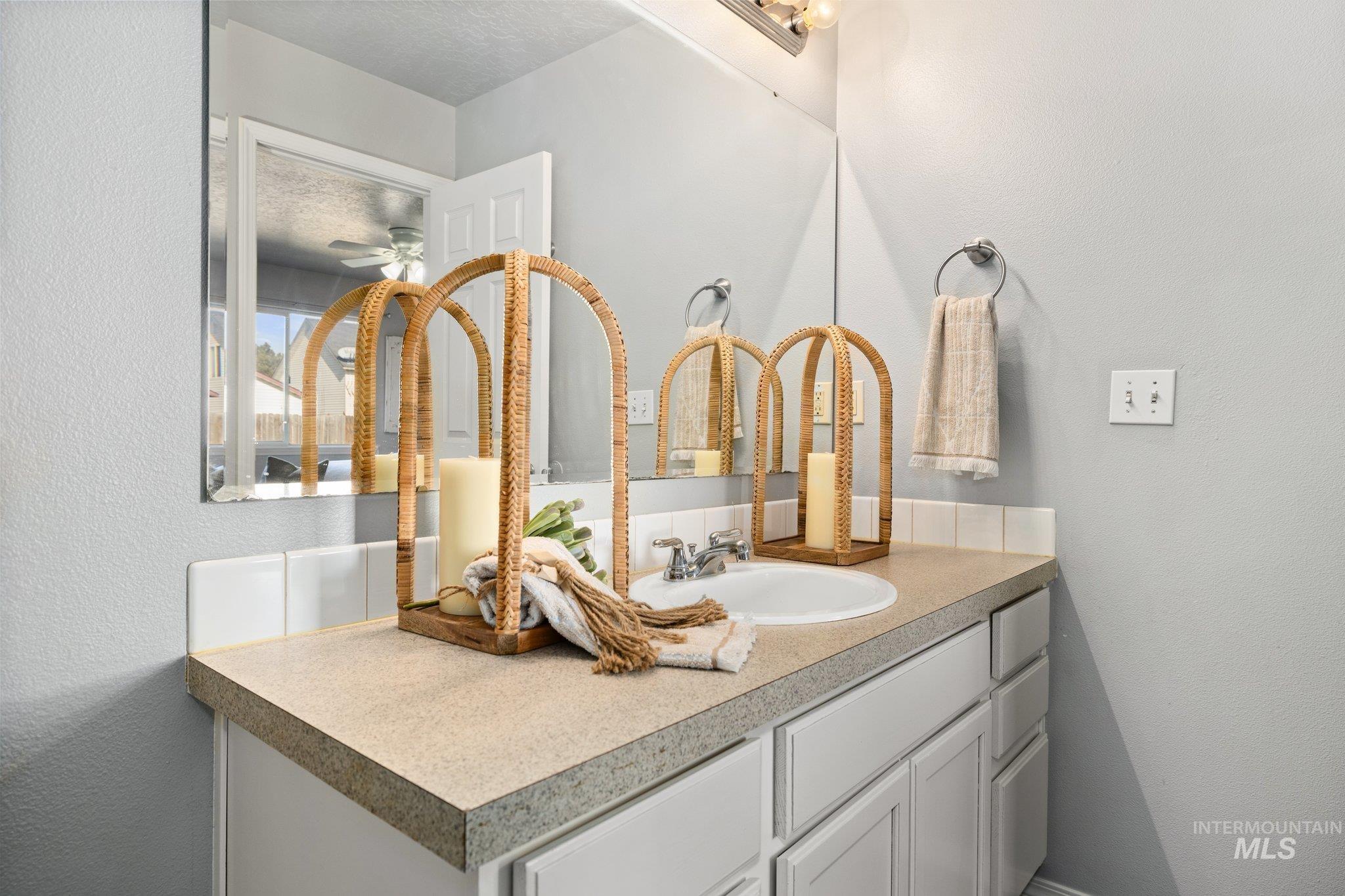 14250 Blue Ridge Street Caldwell, ID 83607 - Photo 20 of 33 Bathroom with a textured wall, vanity, and ceiling fan