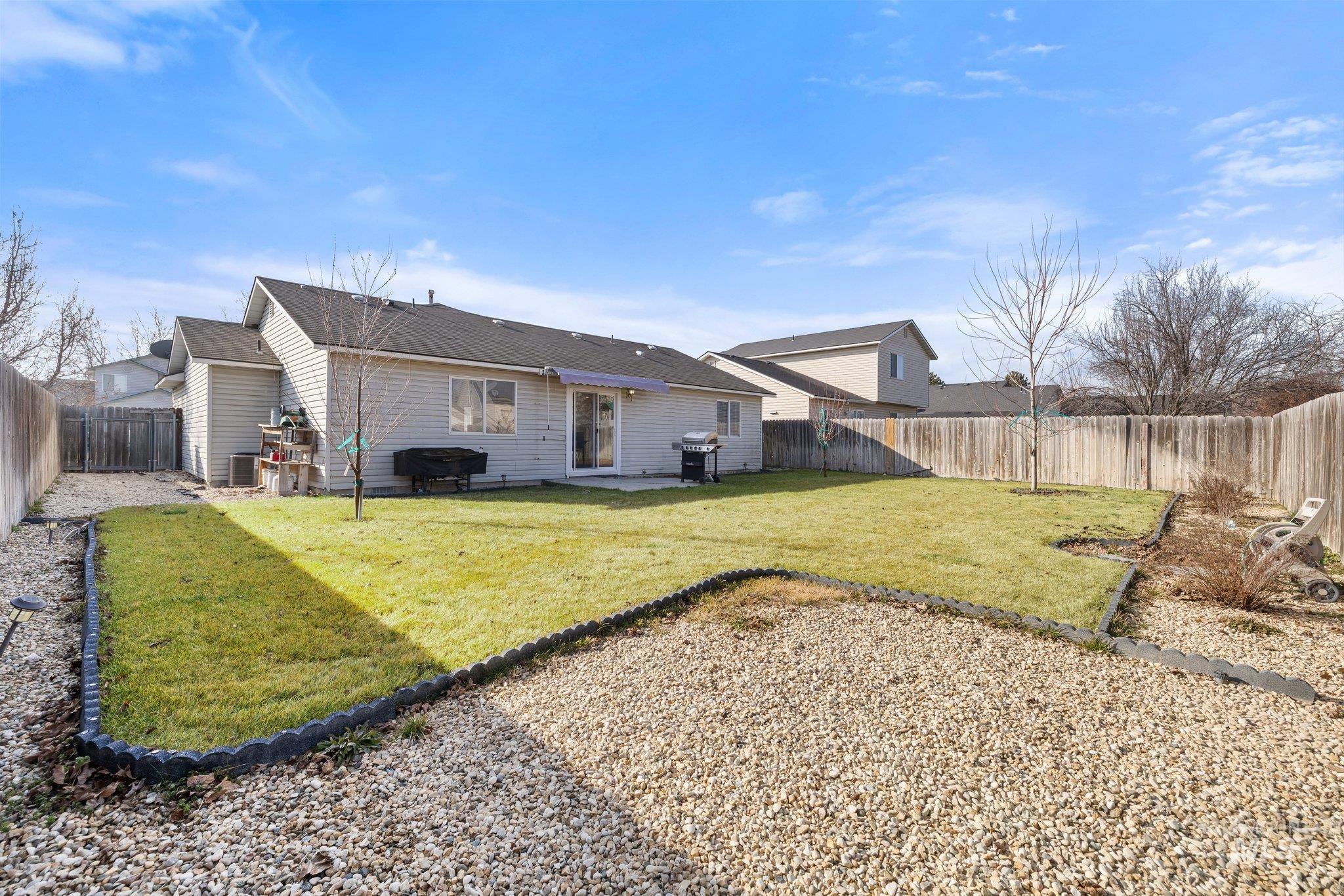 14250 Blue Ridge Street Caldwell, ID 83607 - Photo 30 of 33 Rear view of house featuring a patio area, a fenced backyard, and a shingled roof