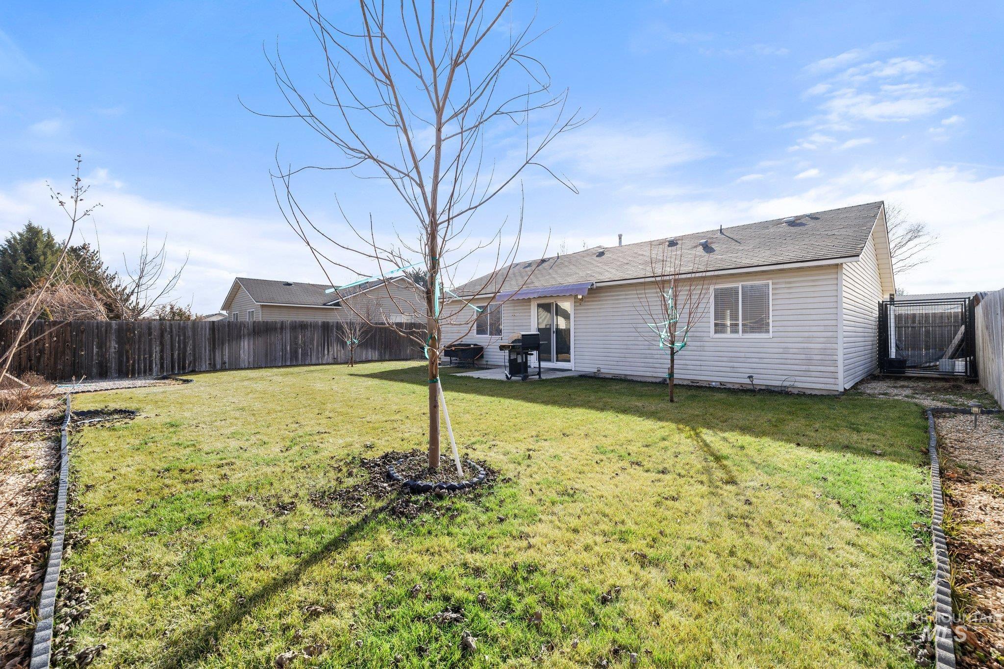 14250 Blue Ridge Street Caldwell, ID 83607 - Photo 31 of 33 Rear view of house with a fenced backyard, a patio area, and a shingled roof