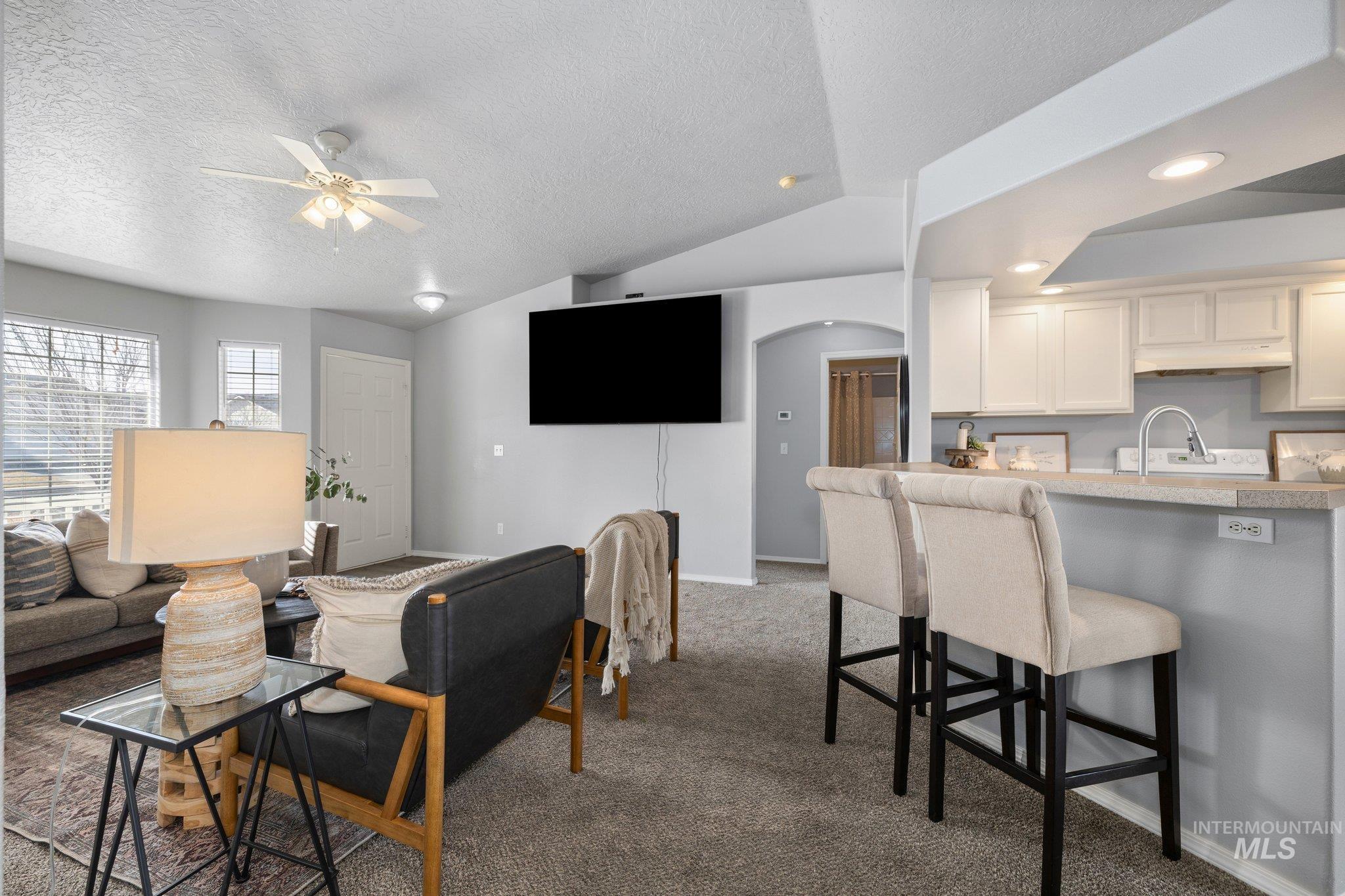 14250 Blue Ridge Street Caldwell, ID 83607 - Photo 7 of 33 Living area with arched walkways, dark colored carpet, a ceiling fan, and recessed lighting