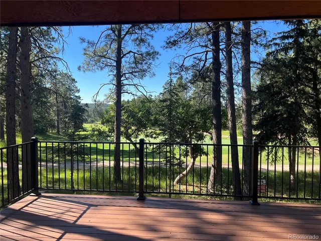 a view of a deck with wooden floor and outdoor seating