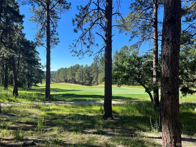 a backyard of a house with a yard and outdoor seating