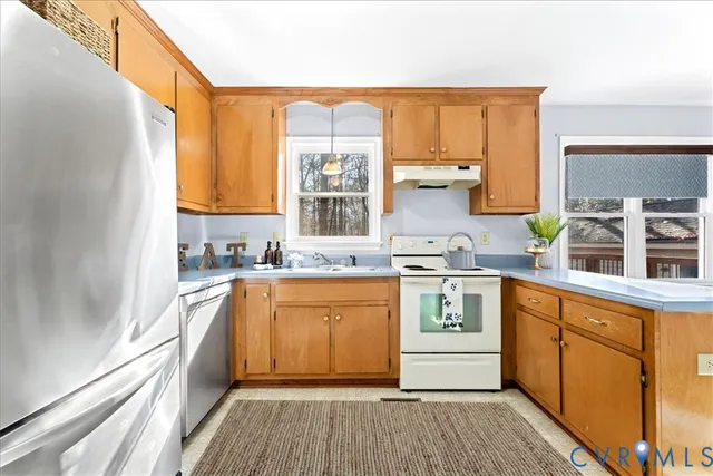 a kitchen with stainless steel appliances granite countertop a stove and a sink