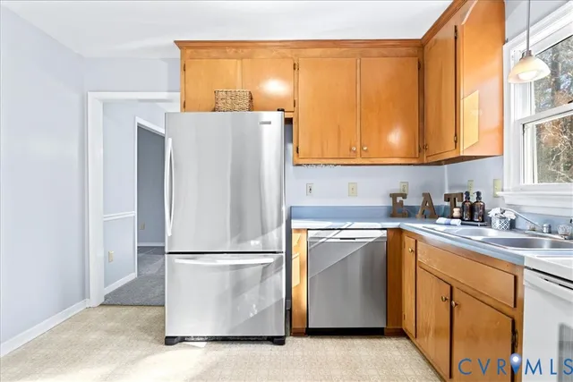 a kitchen with a refrigerator sink and cabinets