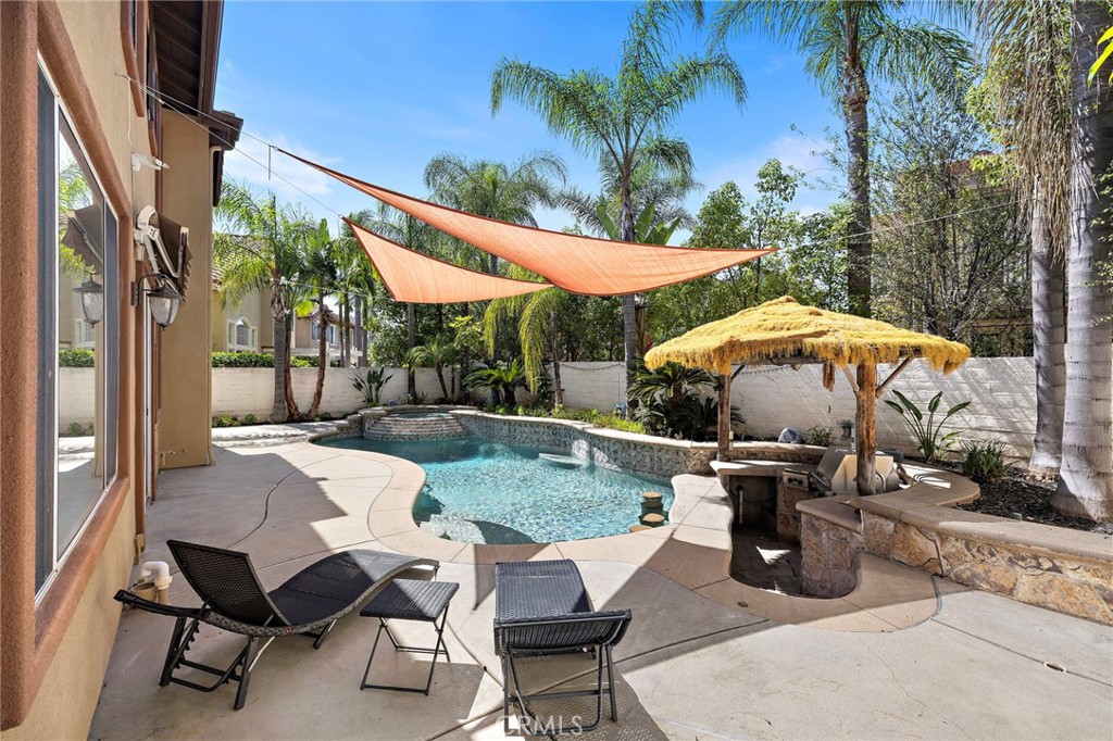 11625 Allen Tustin, CA 92782 - Photo 20 of 45 a view of a patio with a table and chairs under an umbrella