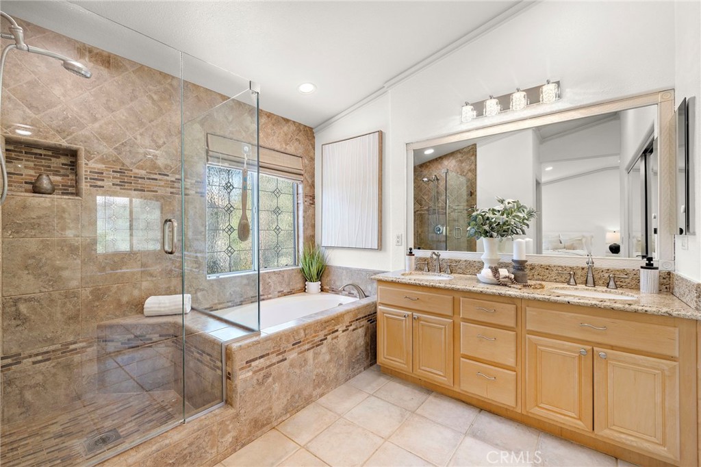 11625 Allen Tustin, CA 92782 - Photo 27 of 45 a spacious bathroom with a double vanity sink a mirror and a bathtub