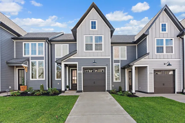 a front view of a house with a yard and garage