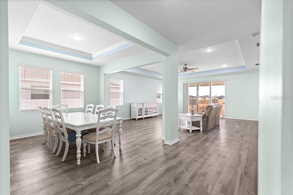 5851 Southwest 85th Place Ocala, FL 34476 - Photo 12 of 57 a view of a dining room with furniture and wooden floor