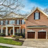 a front view of a house with garden and porch