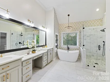 a bathroom with a double vanity sink mirror and bathtub