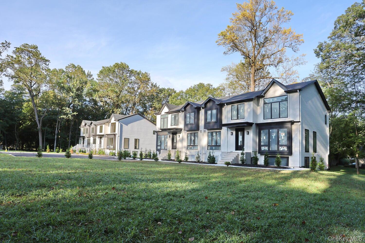 619 Union Road, Unit 202 Spring Valley, NY 10977 - Photo 2 of 6 View of front of home with a front yard, stucco siding, and a residential view