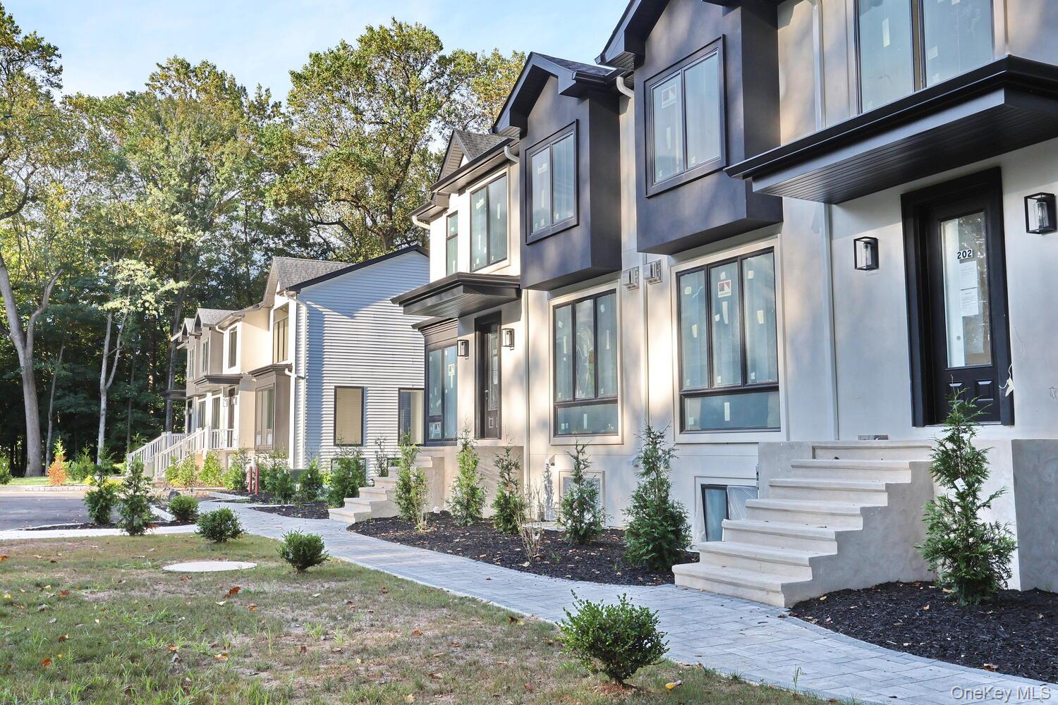 619 Union Road, Unit 202 Spring Valley, NY 10977 - Photo 3 of 6 View of property exterior with stucco siding