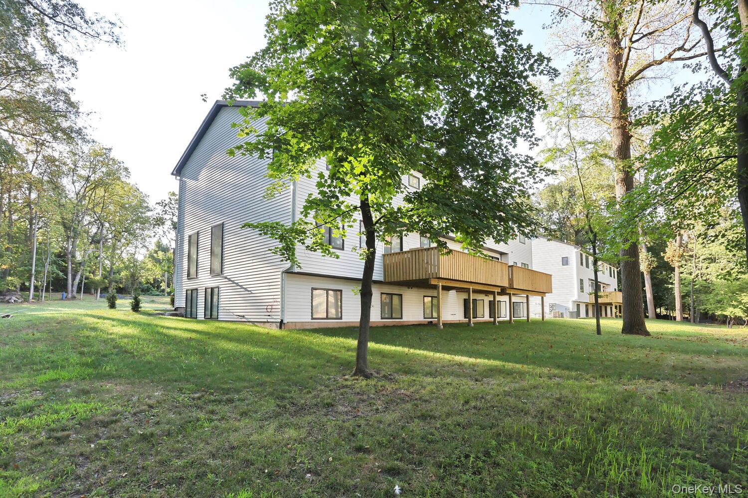 619 Union Road, Unit 202 Spring Valley, NY 10977 - Photo 4 of 6 Back of property featuring a yard and a wooden deck