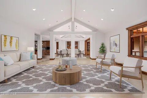 a living room with fireplace furniture and a chandelier