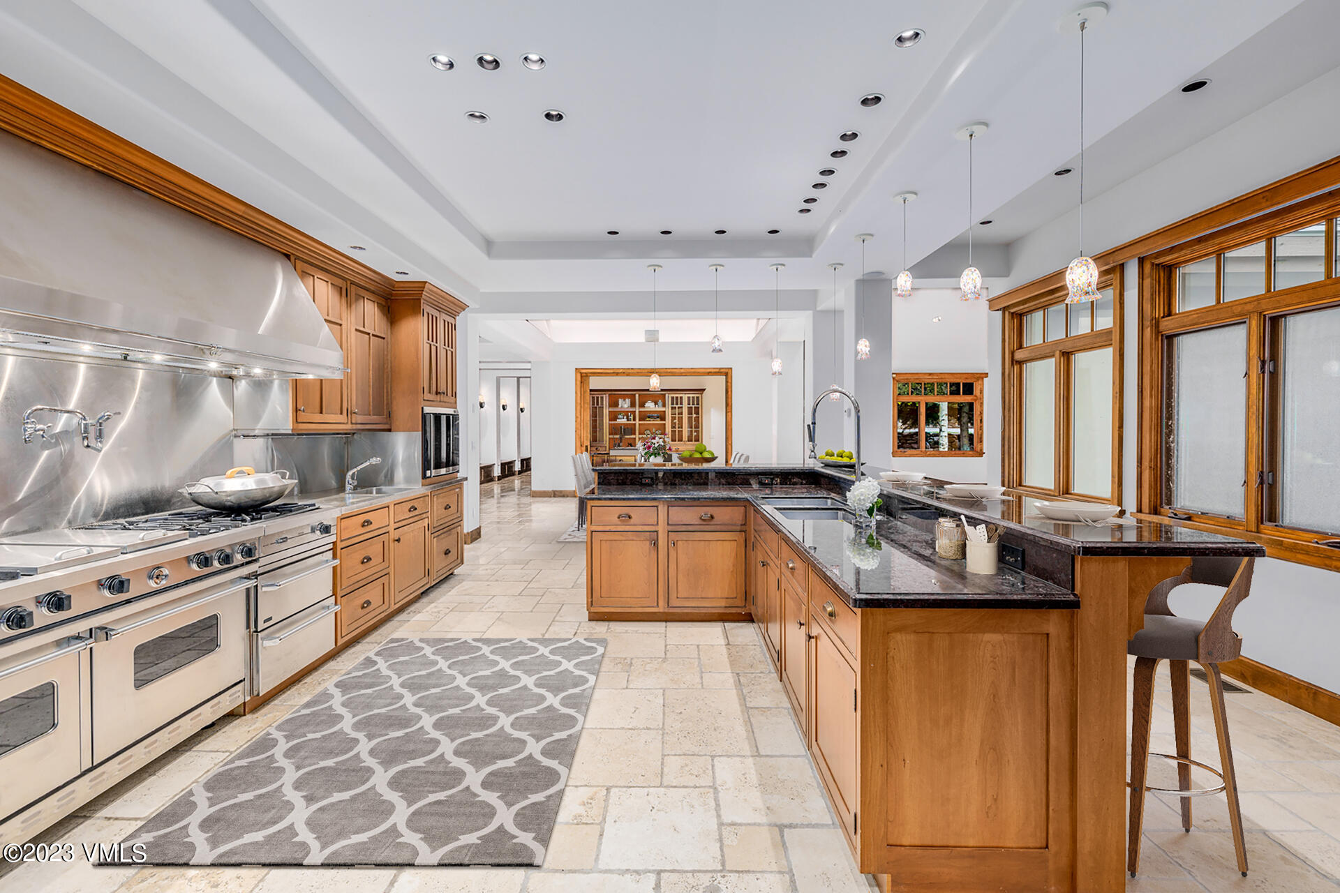 983 Beard Creek Road Edwards, CO 81632 - Photo 15 of 29 a large kitchen with stainless steel appliances granite countertop a stove a sink dishwasher and cabinets with wooden floor