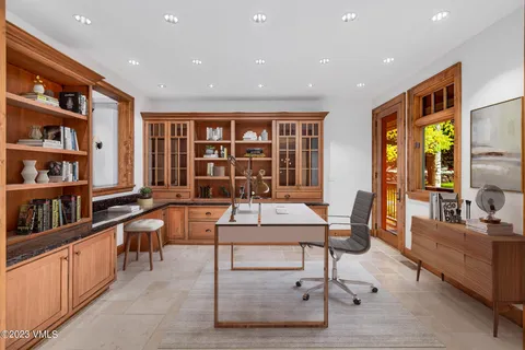 a living room with furniture a window and bookshelf