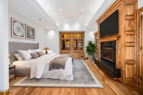 a spacious bedroom with a large bed and a fireplace