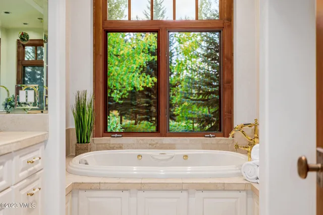 a white bath tub sitting next to a window