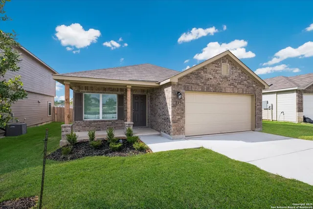 a view of a house with a yard and a garden