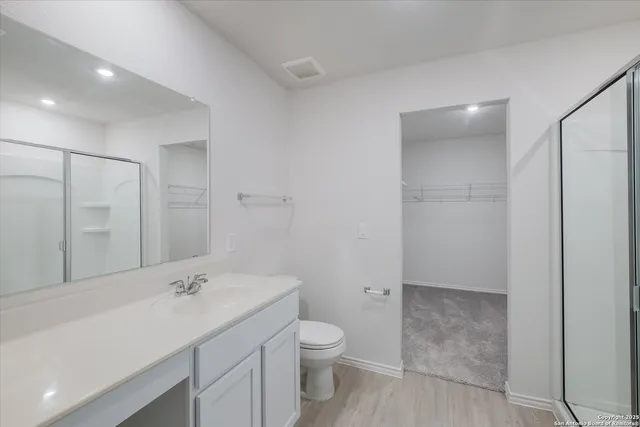 a bathroom with a toilet a sink and mirror