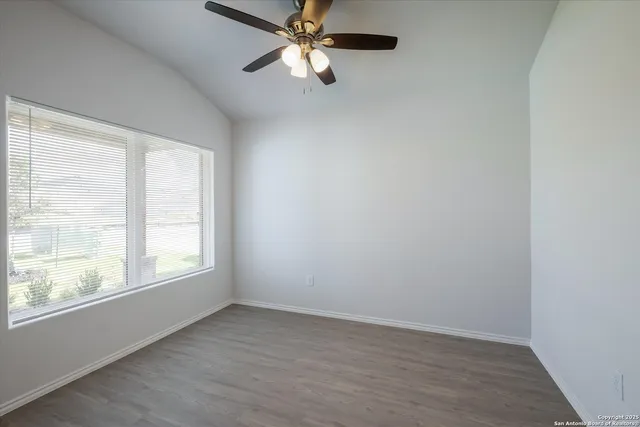 wooden floor in an empty room with a window