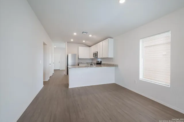 a view of kitchen with wooden floor