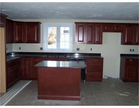Lot 29 Bronson Street Fall River, MA 02721 - Photo 4 of 5 a kitchen with wooden cabinets