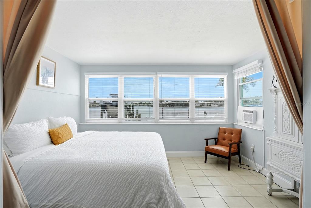 2311 Bay Boulevard Indian Rocks Beach, FL 33785 - Photo 21 of 80 a bedroom with a bed and a balcony view