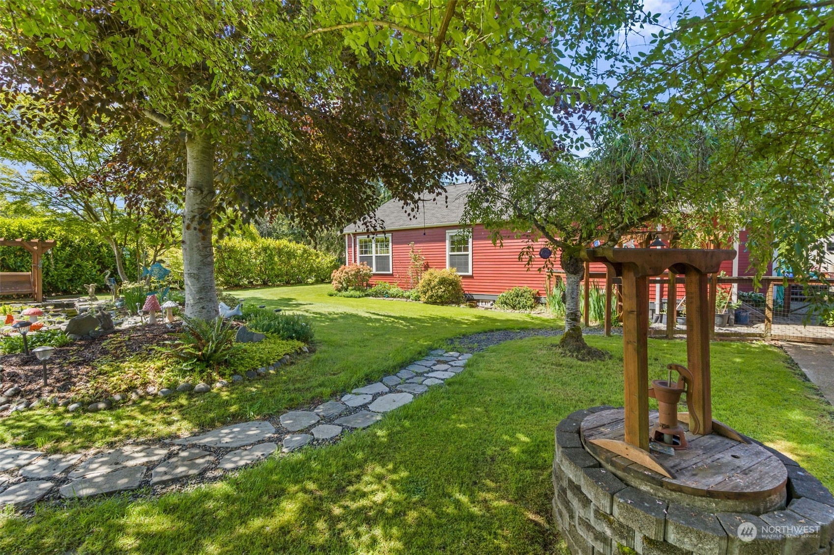 916 McLeod Road Bellingham, WA 98226 - Photo 26 of 40 a view of a house with backyard sitting area and garden