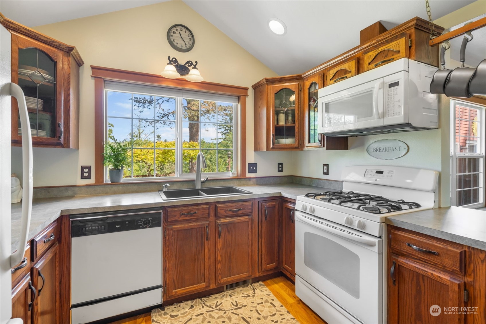 916 McLeod Road Bellingham, WA 98226 - Photo 7 of 40 a kitchen with stainless steel appliances granite countertop a stove a sink and a microwave