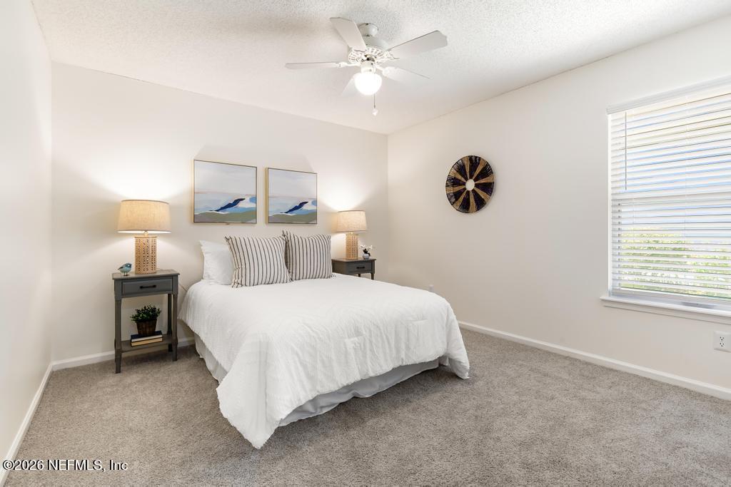12223 Springmoor One Court Jacksonville, FL 32225 - Photo 12 of 29 a bedroom with a bed and a night stand