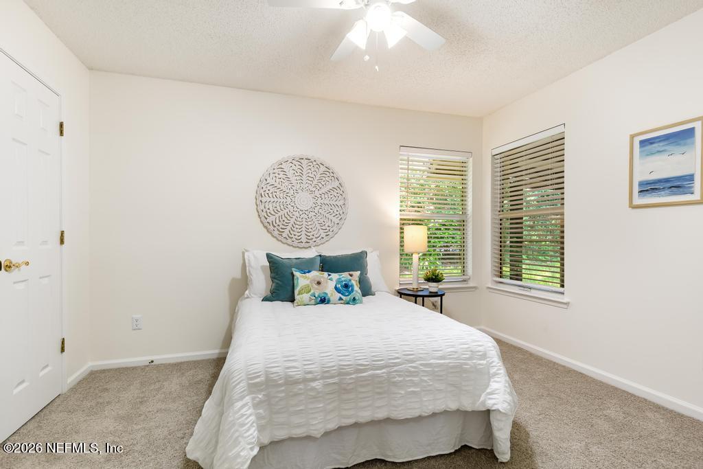 12223 Springmoor One Court Jacksonville, FL 32225 - Photo 15 of 29 a bed sitting in a bedroom next to a window