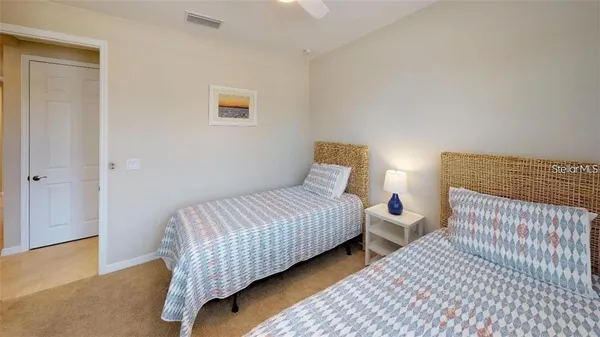 a bedroom with beds and a night stand