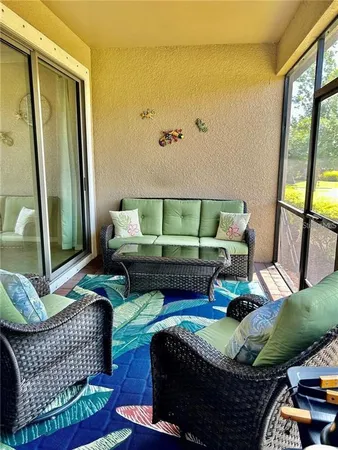 a living room with furniture fireplace and a large window