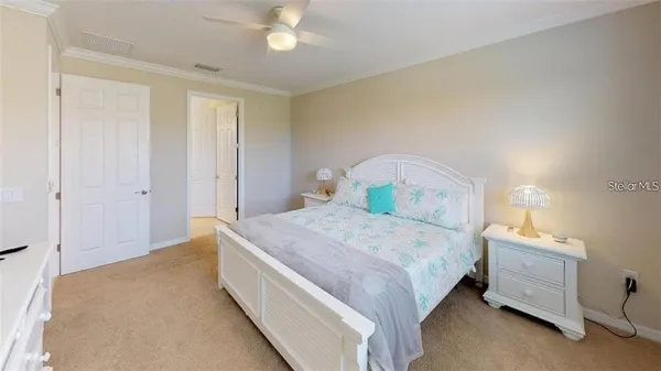 a bedroom with a bed and a chandelier